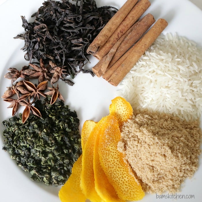 plate with teas orange peel, cinnamon stick, rice, anise and brown sugar ready for smoking.