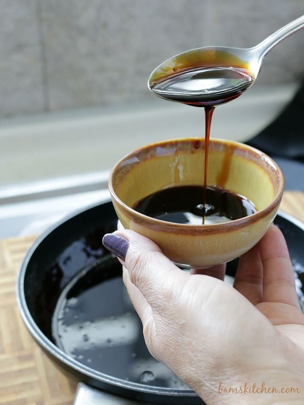 Amakuchi sauce getting poured into a little brown pottery bowl