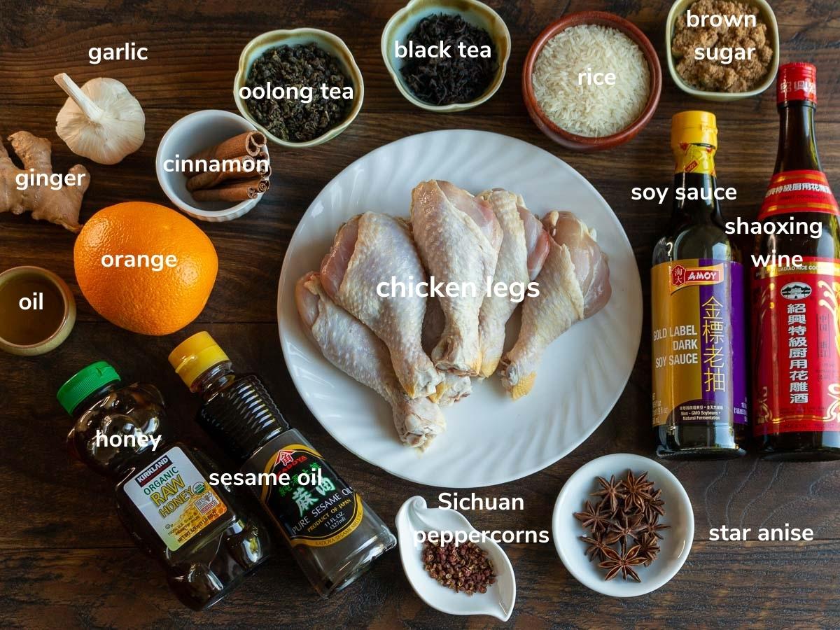 Ingredients to make Chinese smoked chicken on a wooden table.