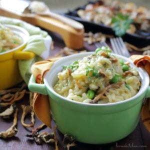 Chanterelle Mushroom risotto in a green bowl topped with parmesan.