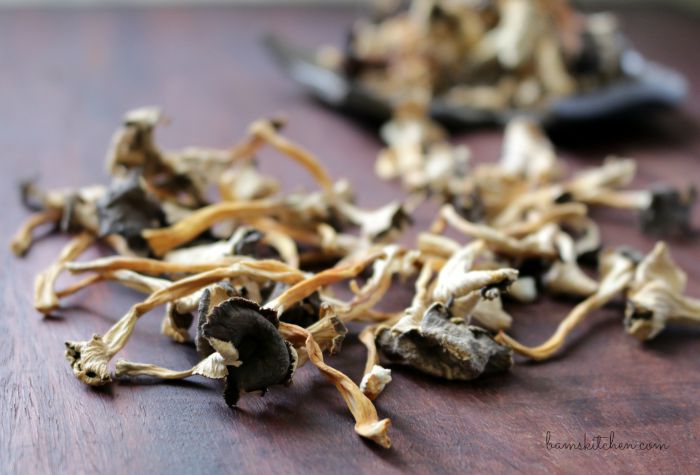 Dried chanterelle mushrooms on a wooden board. 