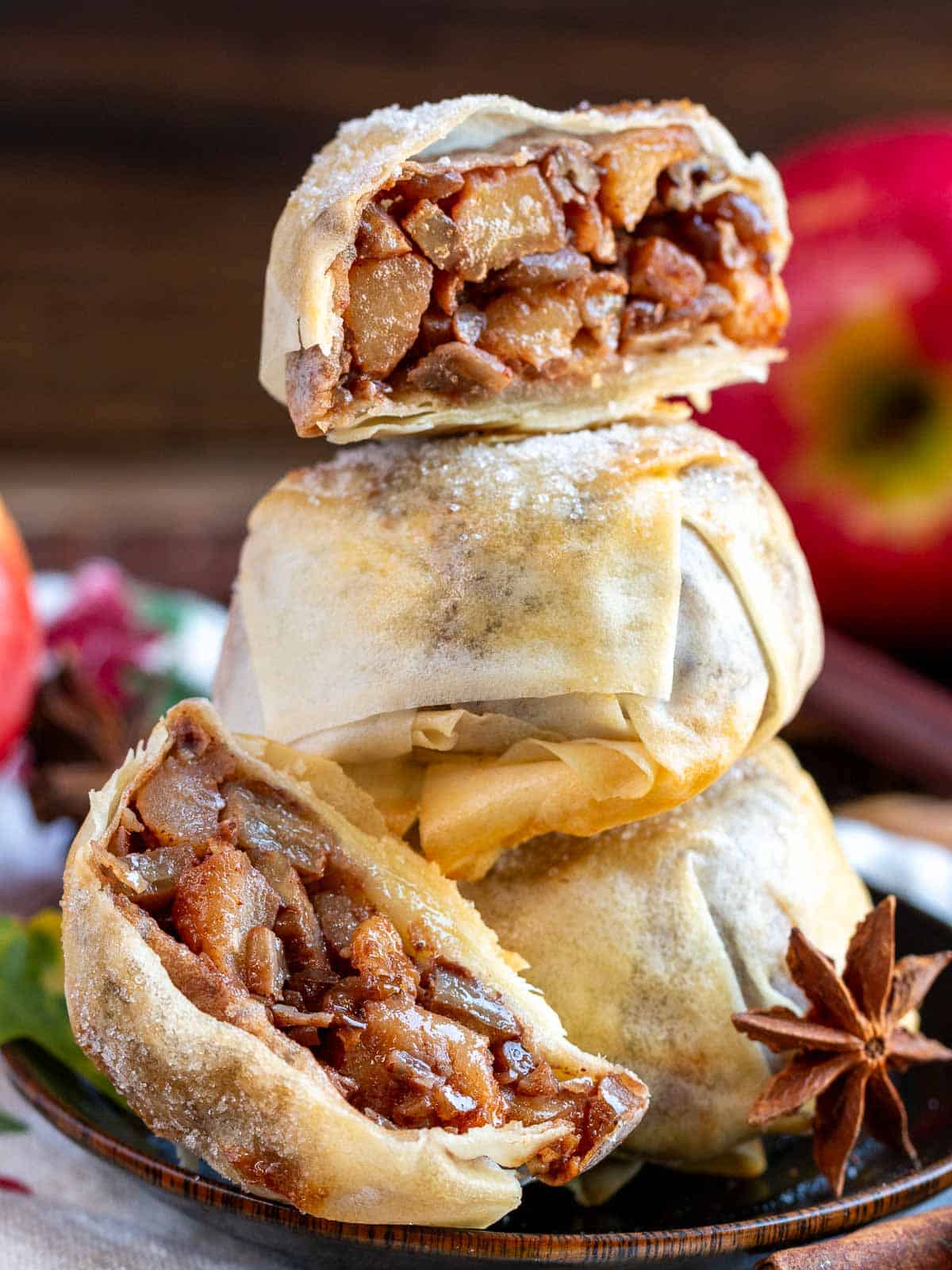 Mooncakes cut in half showing the caramelized apples and pecans and flaky crust. 