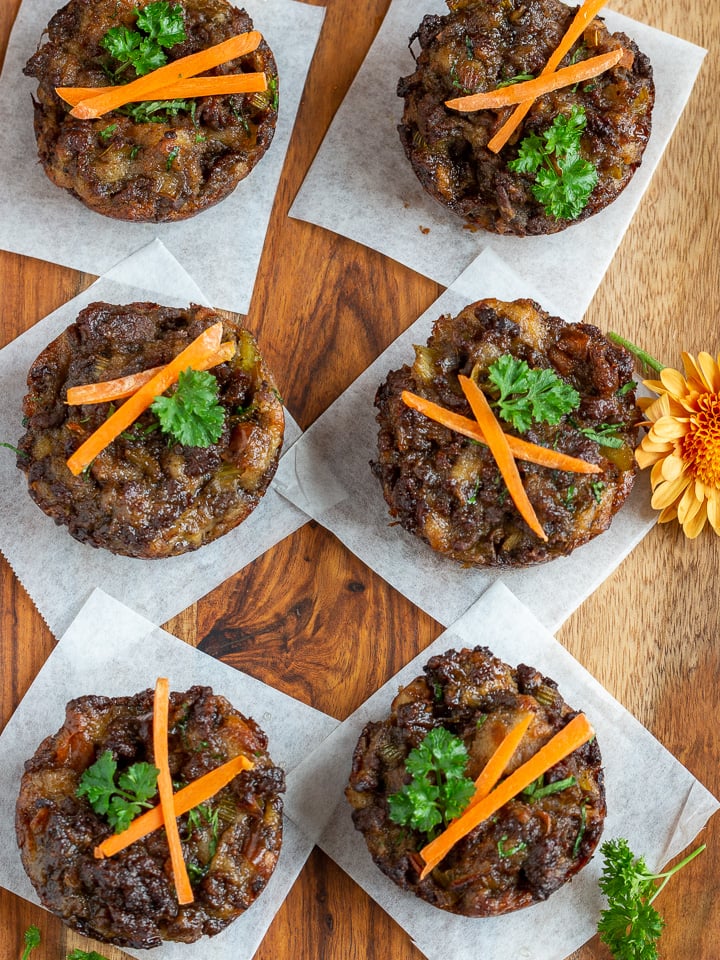 6 individual dressings made in a muffin tin on a wooden serving platter.