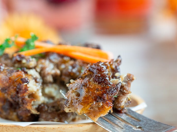 The bite shot showing a super crispy edge to the meaty French Canadian dressing on a fork.
