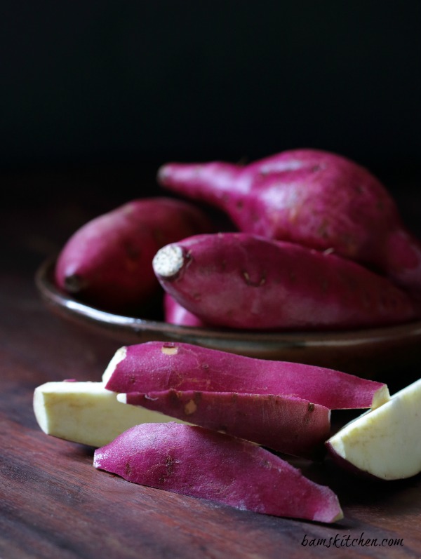 Japanese bright purple sweet potatoes in a brown Japanese pottery bowl.