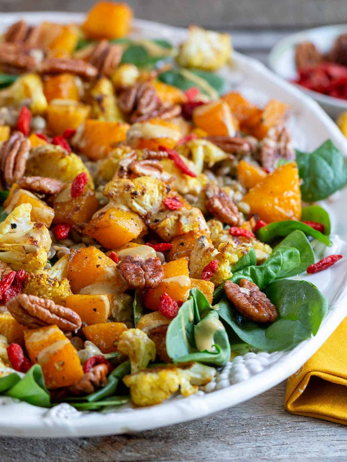 Ready to eat warm autumn salad in a beautiful white serving tray.
