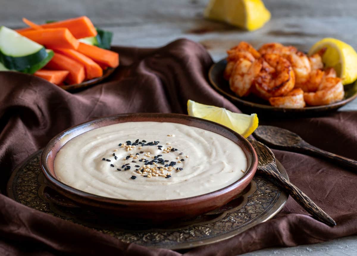 Serving the dip with spicy shrimp and fresh carrots and cucumbers  as an appetizer. 