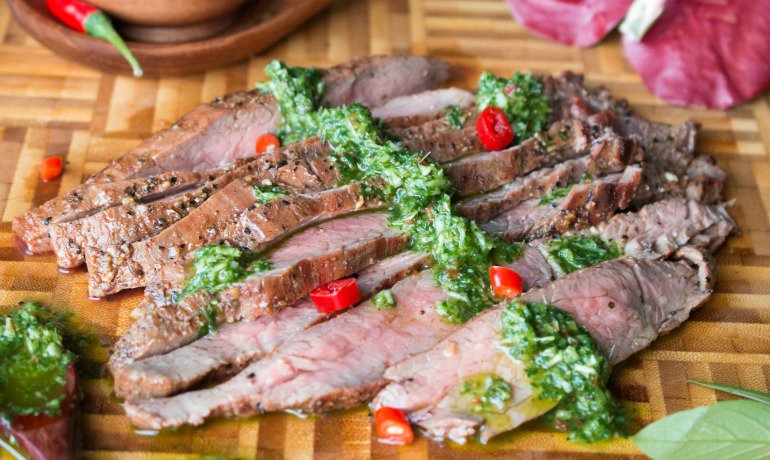 Smothered with Thai chimichurri sauce steak slices. 