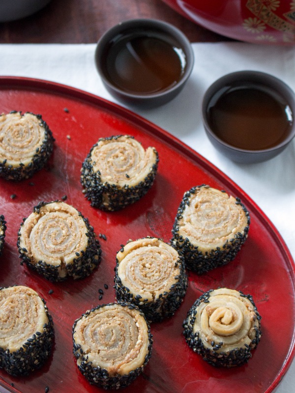 Cookies with tahini inside on red plate.