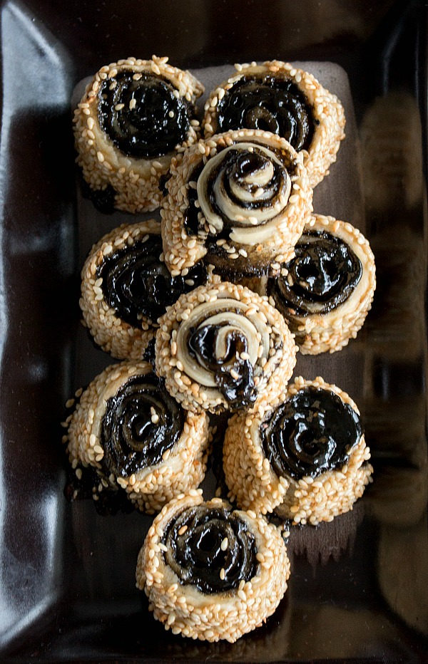 9 Pinwheel Cookies on a dark brown cookie platter.