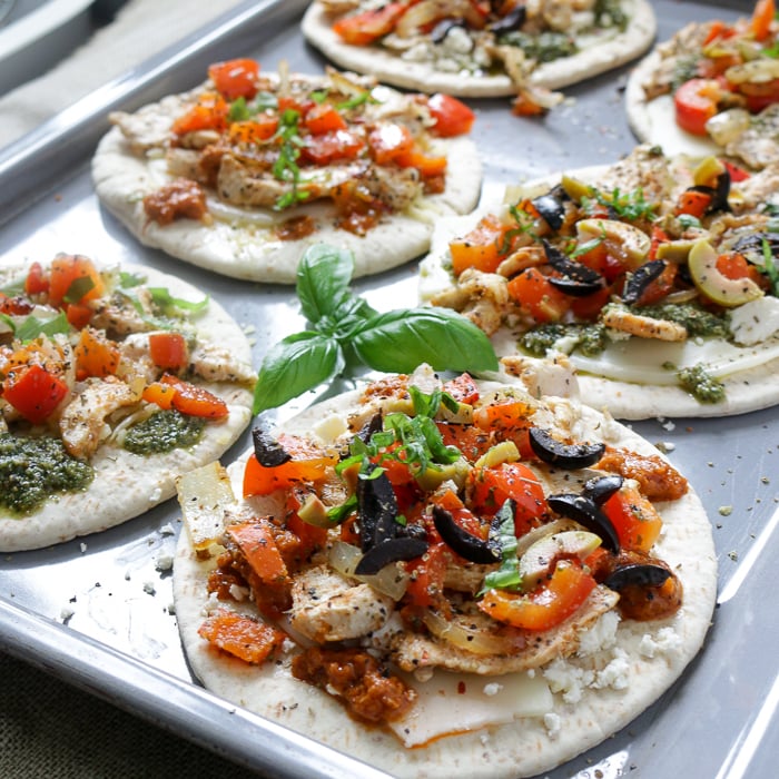 Pizza on baking sheet ready for oven.