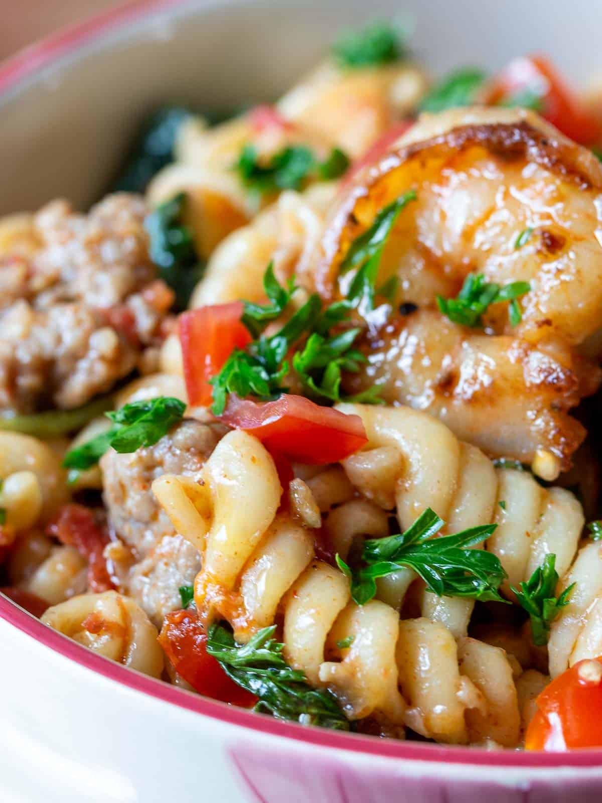 Close up shot of all the delicious sauce around each of the curves of the corkscrew pasta.