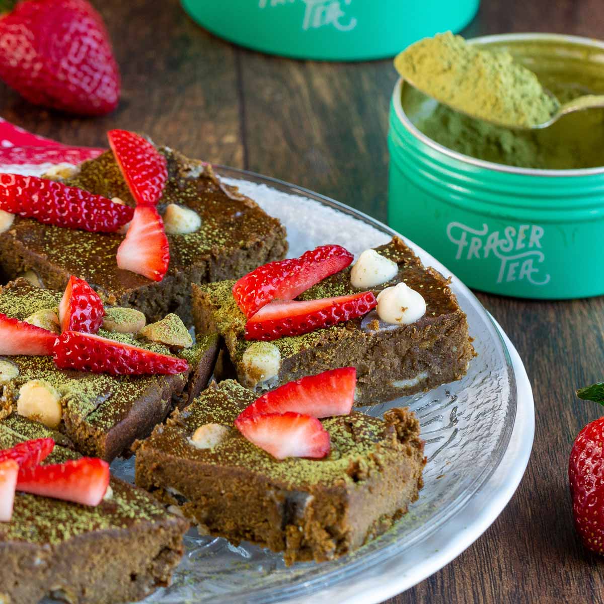 Matcha Brownie with white chocolate chips garnished with strawberries.