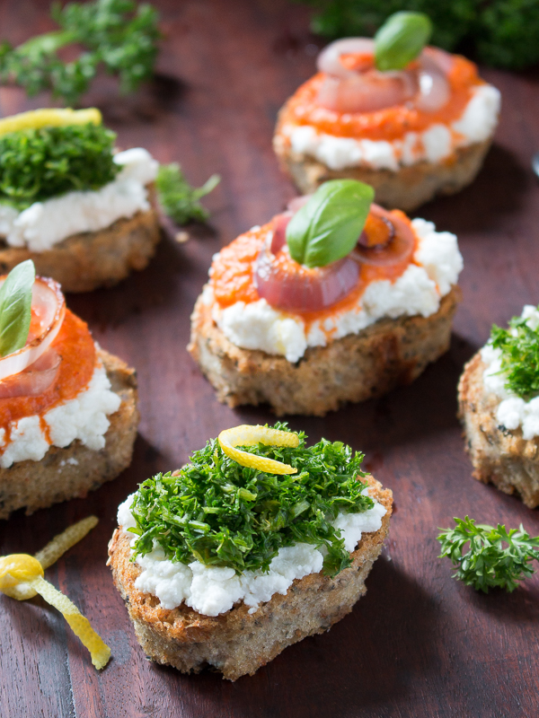Italian toasted crostini appetizers garnished with lemon slices and basil. 