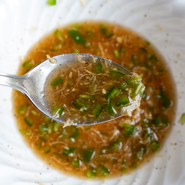 Citrus Ginger jalapeno maple dressing in a white bowl.