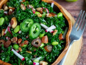 Big bowl of kale salad in a wooden bowl.