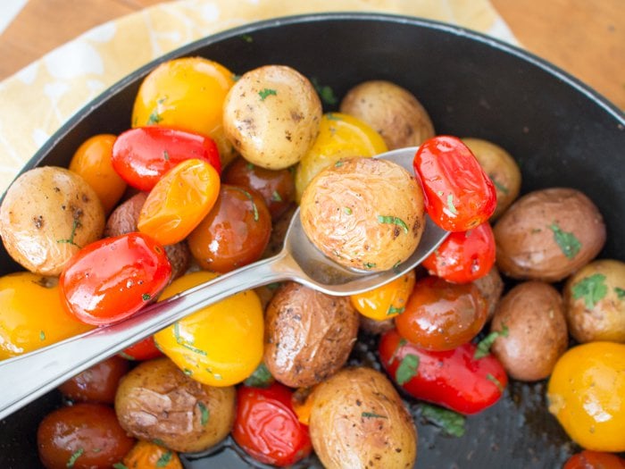 Roasted Baby Potatoes and Tomatoes in a serving spoon. 