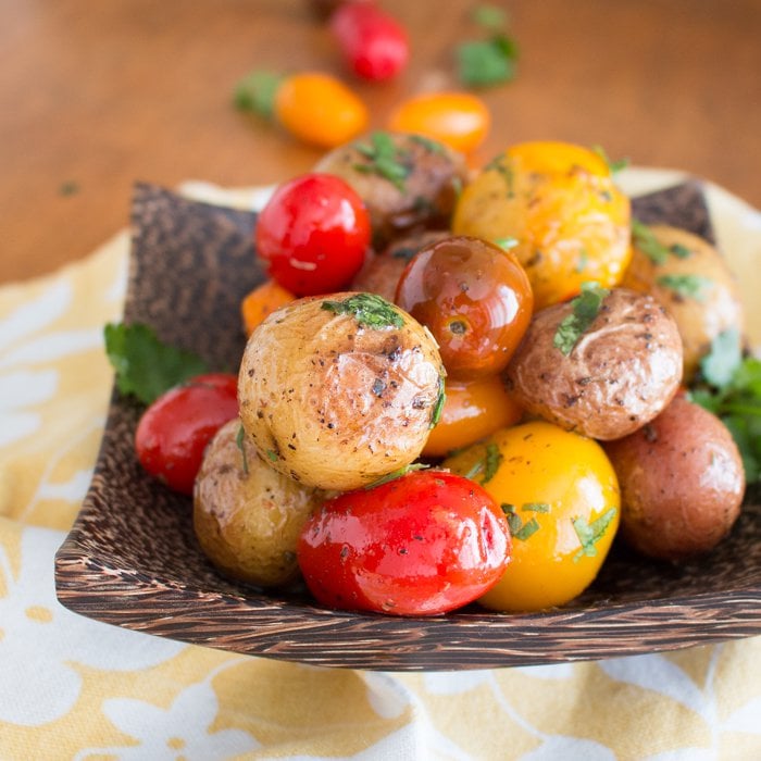 Herbs de Provence Baby Potatoes and Tomatoes in a wooden bowl.