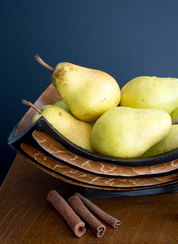 Ripe pears in a wooden bowl.