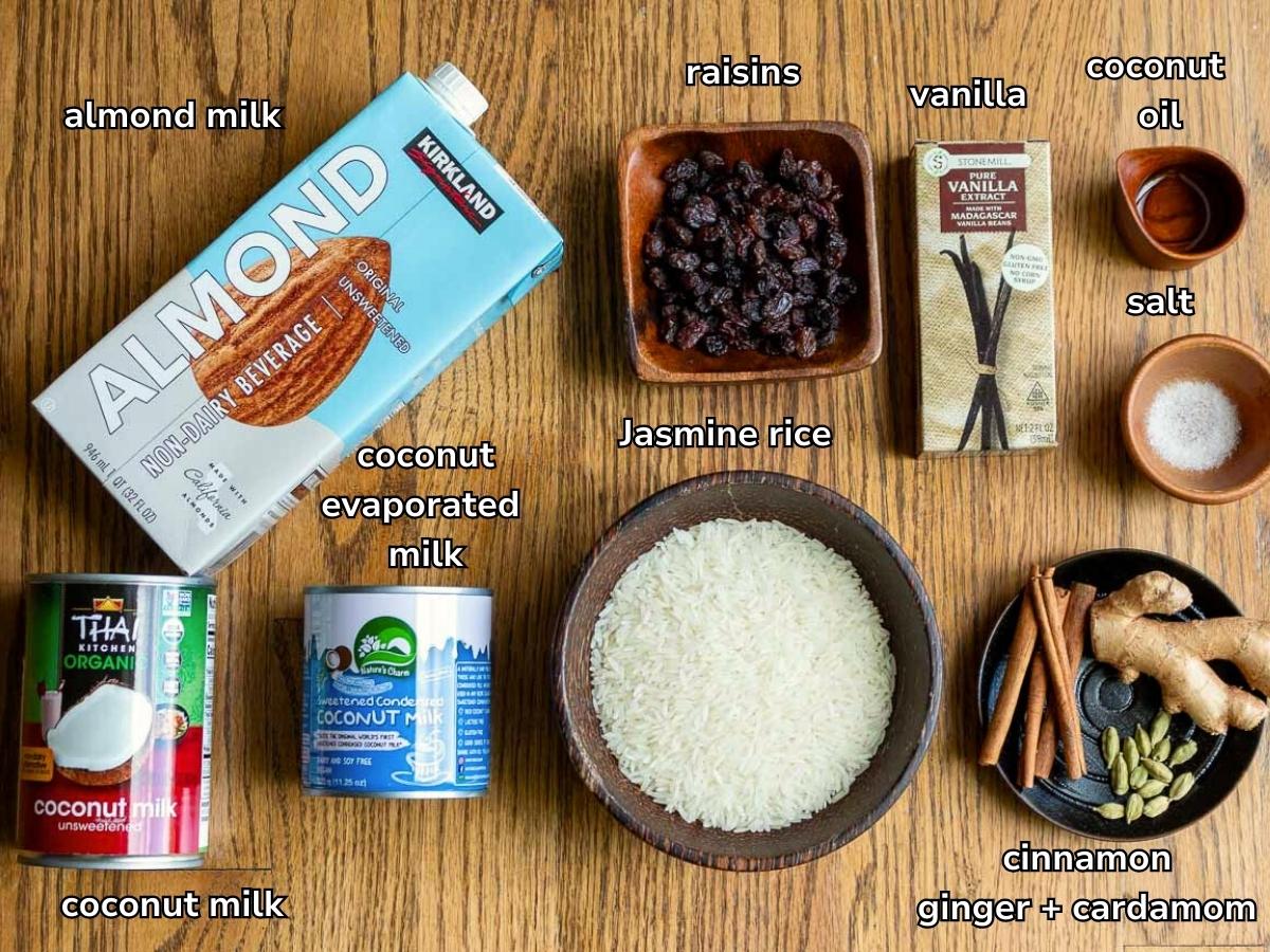 Ingredients to make coconut rice pudding laying on a wooden table. 