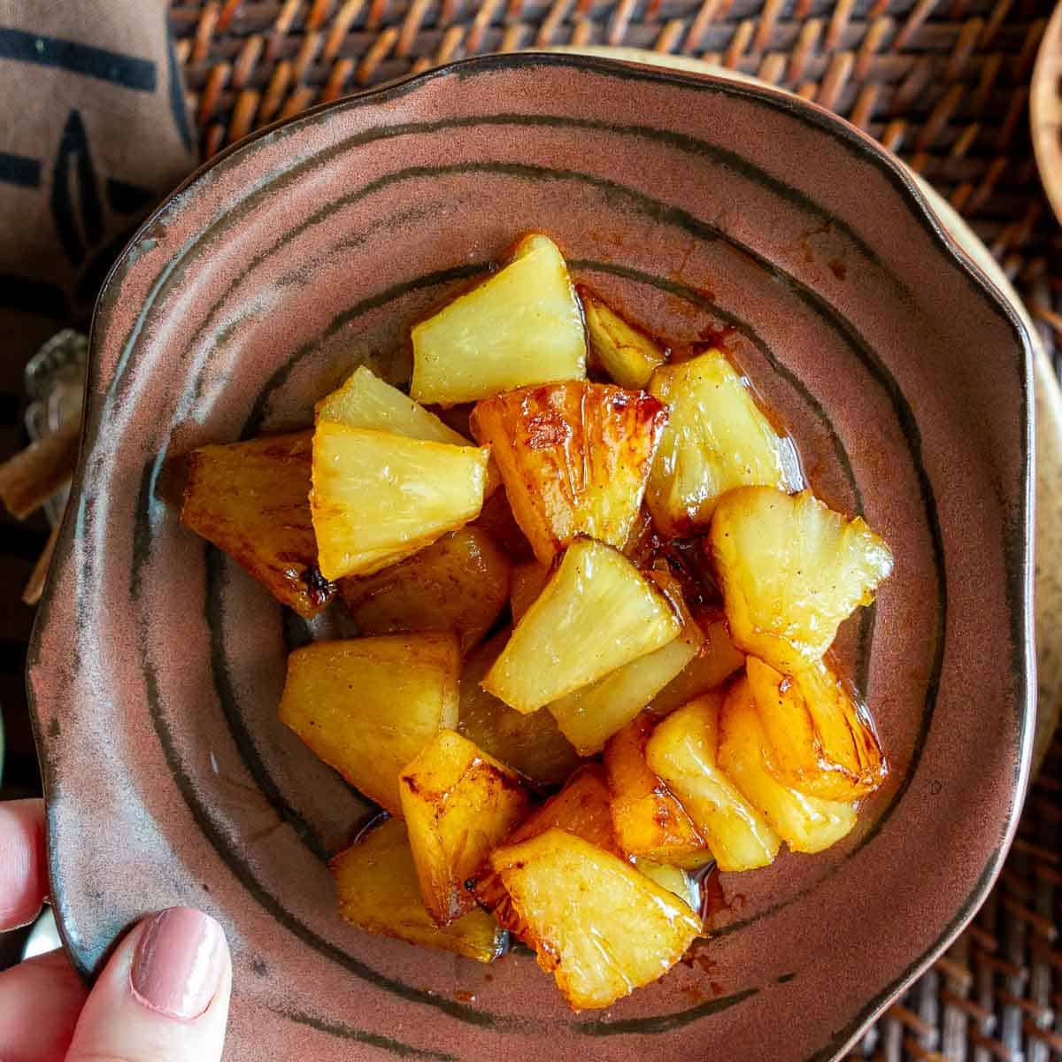 Sauteed pineapple chunks with cardamom and cinnamon - ready to top the rice pudding. 