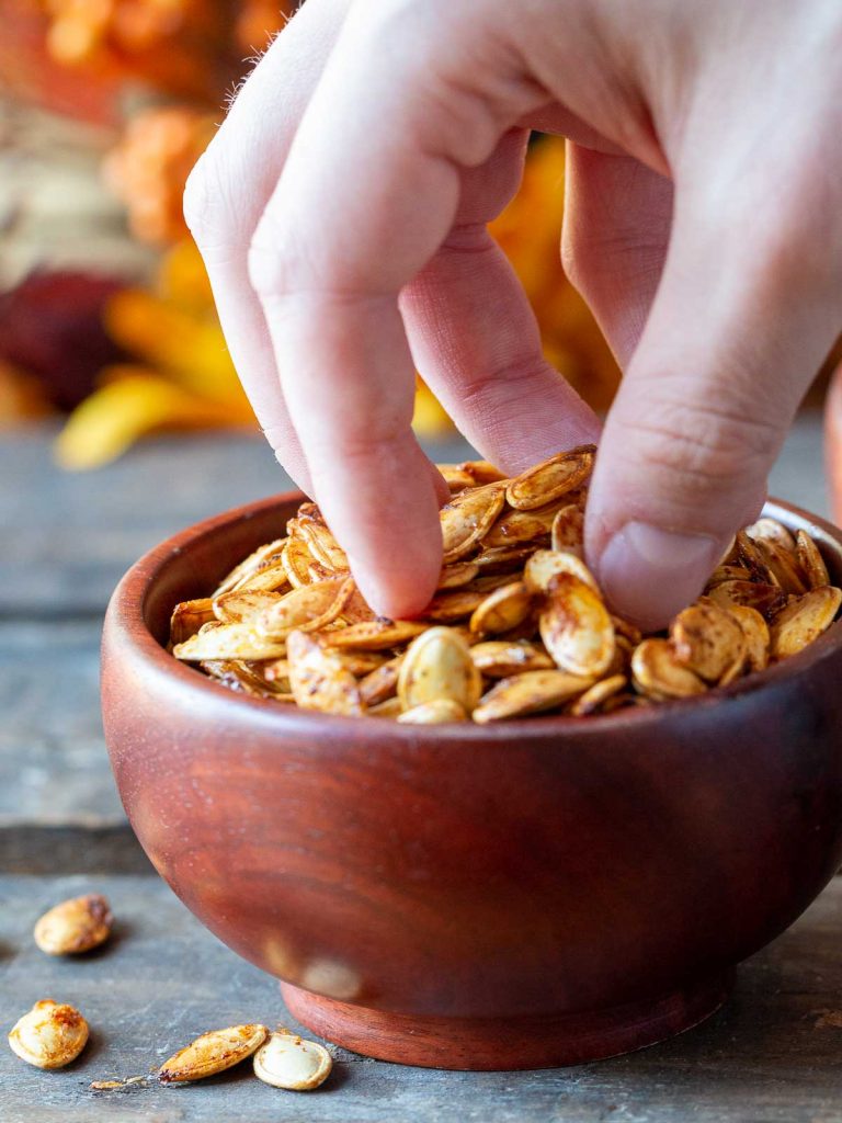 Grabbing a handful of crispy pumpkin seeds.