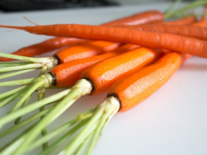 Carrots getting peeled and prepped for the oven.