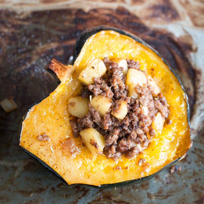 acorn squash still on the baking sheet just filled with the meat mixture.