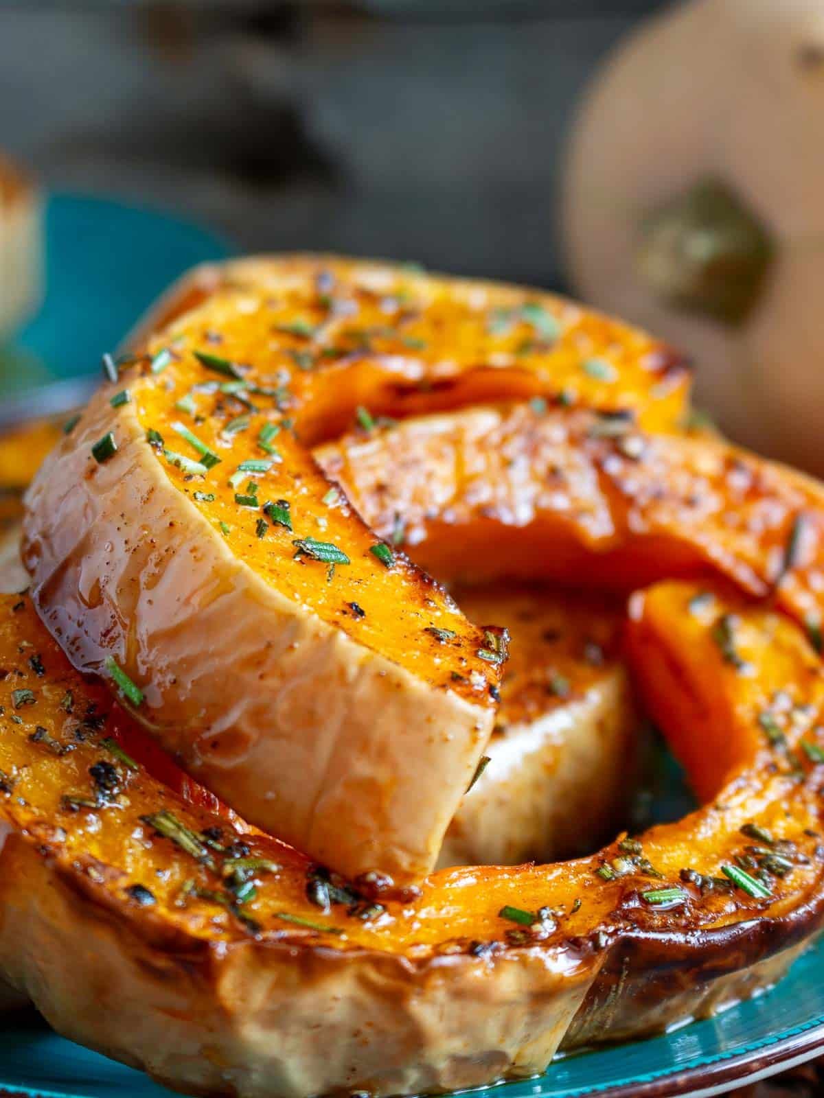 Spicy butternut squash slices on a blue plate.