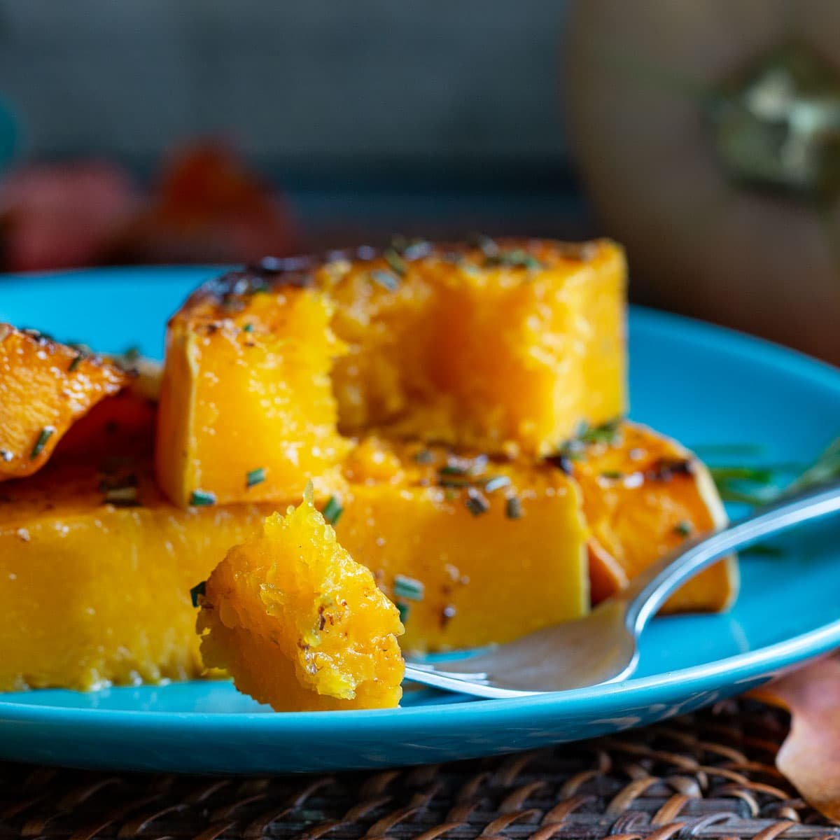 A bite of creamy roasted butternut squash on a fork. 