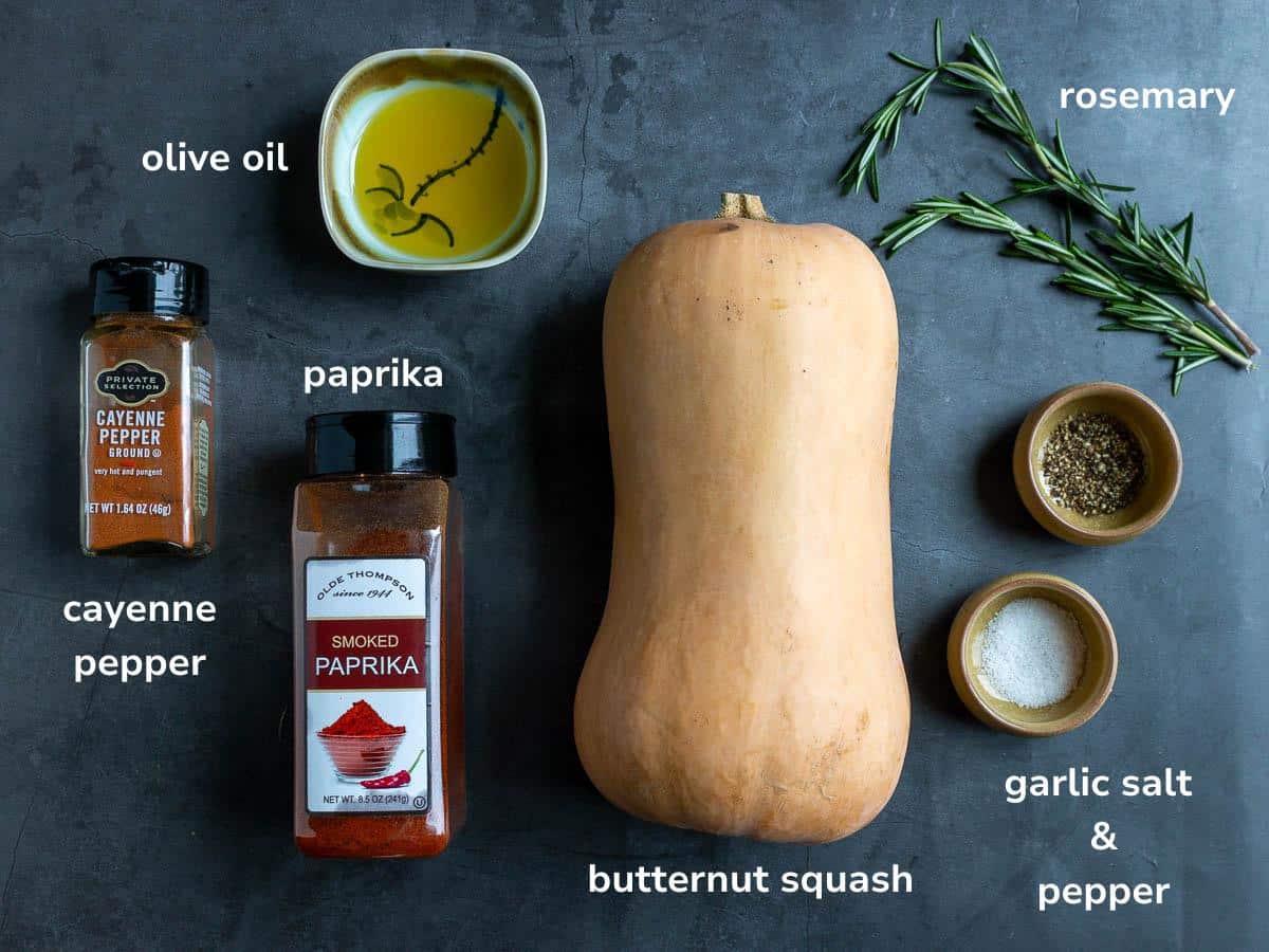 Simple ingredients to make air fried butternut squash laying out on a gray table.