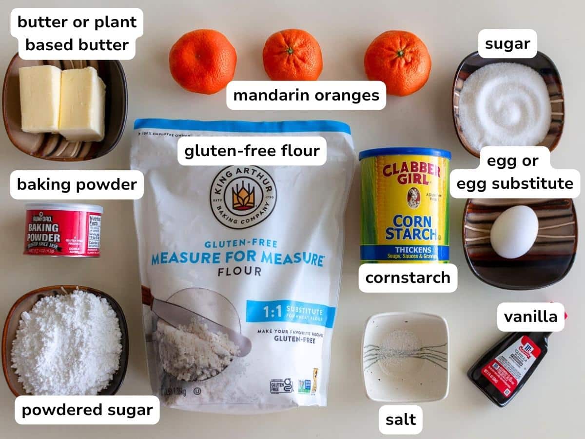 Ingredients to make gluten free orange drop cookies laid out on a beige countertop. 