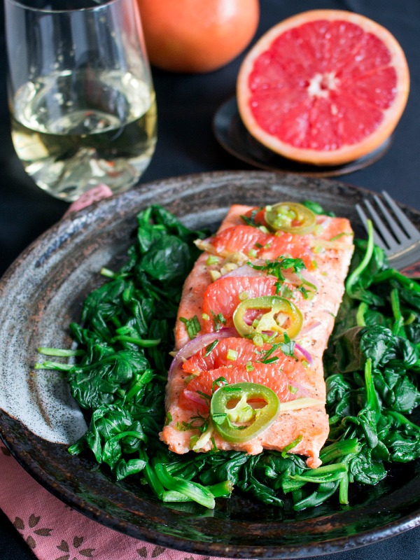 Spicy Citrus Baked Salmon Packets served with a glass of white wine. 