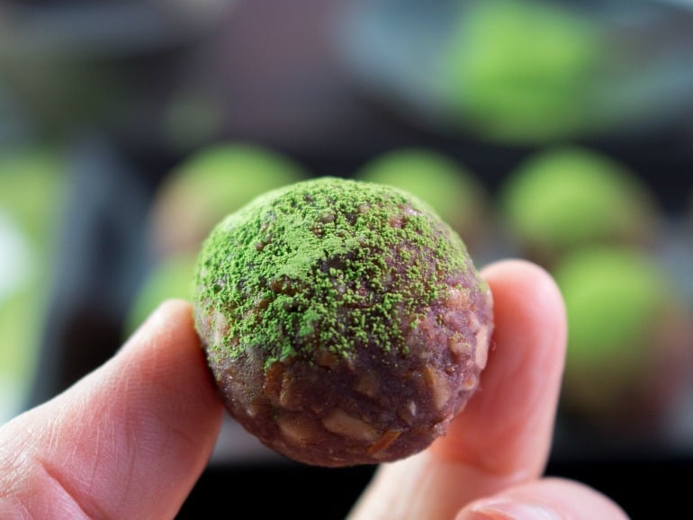 A 1.5 inch matcha ball held in between 2 fingers to show size.