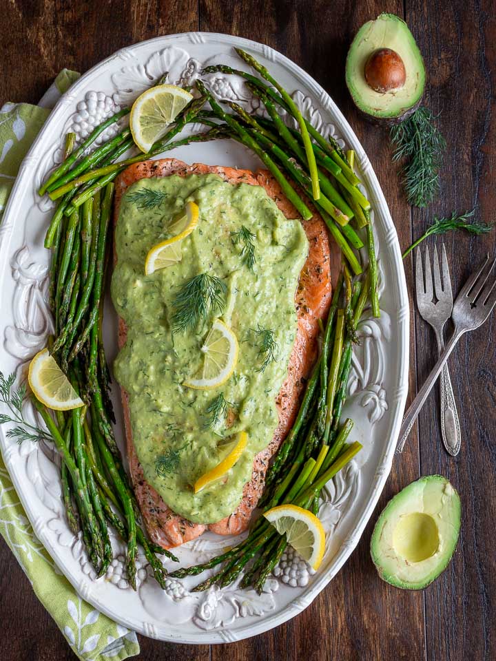 Top down shot of baked salmon in a white serving platter.