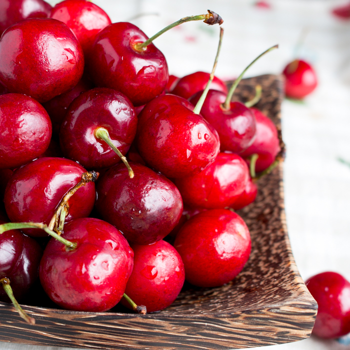 Fresh sweet Michigan cherries in a wooden bowl.