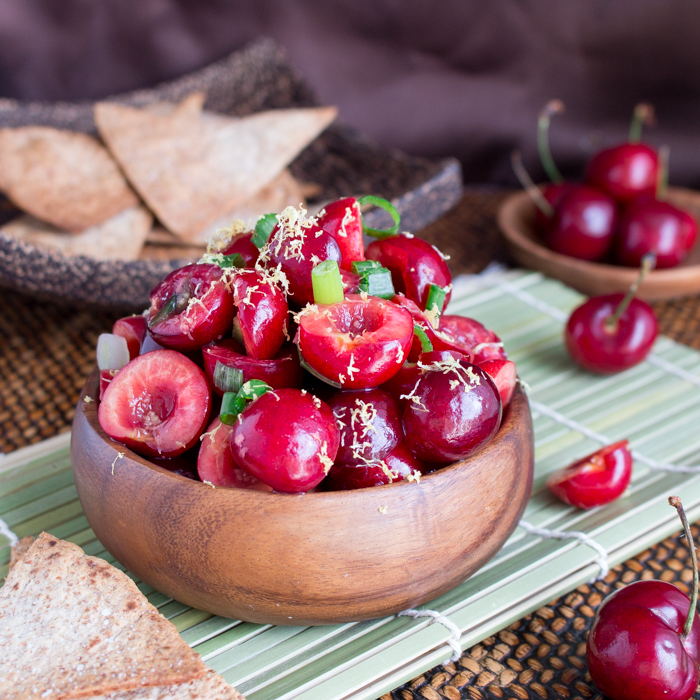 Cherry Ginger Salsa in a wooden bowl with homemade chips.