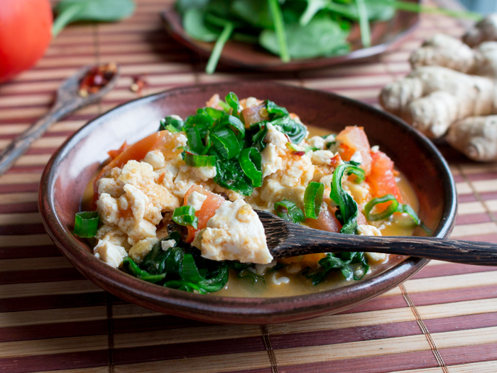 The bite shot of scrambled tofu in a wooden spoon.