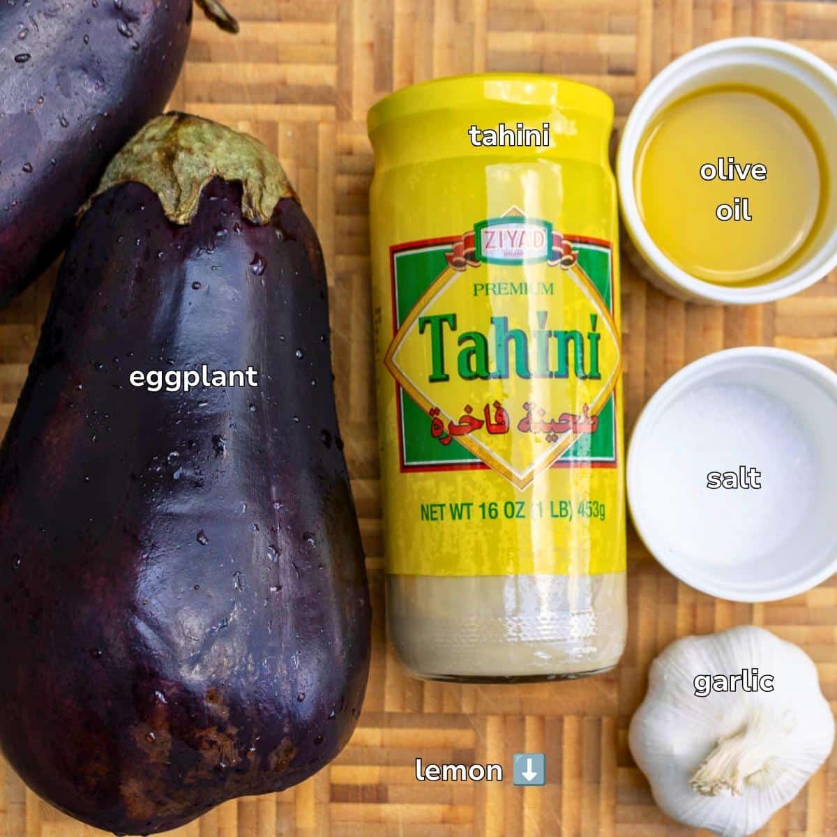 Ingredients to make make an eggplant dip on a wooden board.