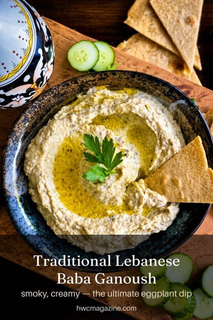 traditonal baba ganoush with warm pita on a wooden board.