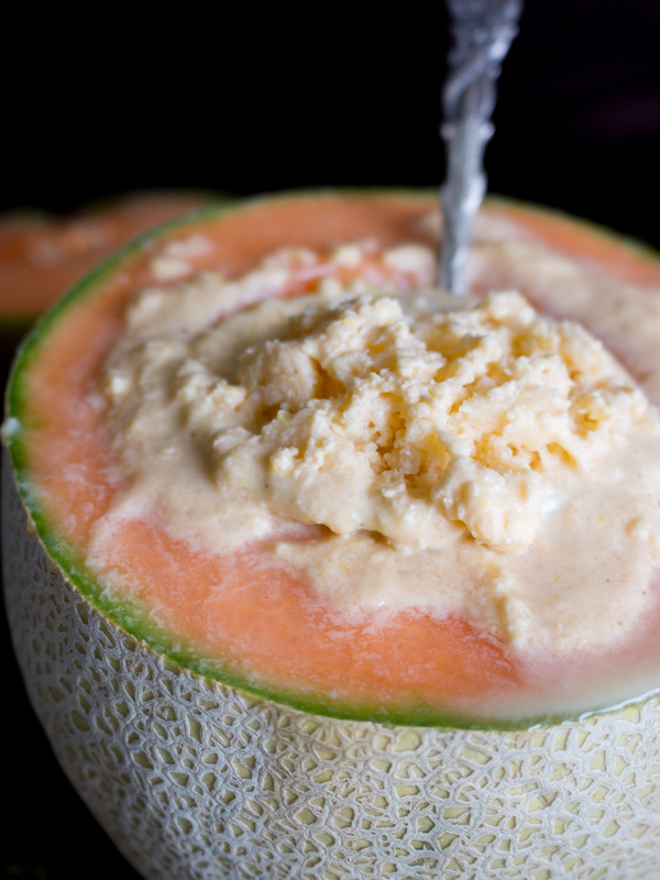 Spoon in a serving of sorbet inside half of a cantaloupe