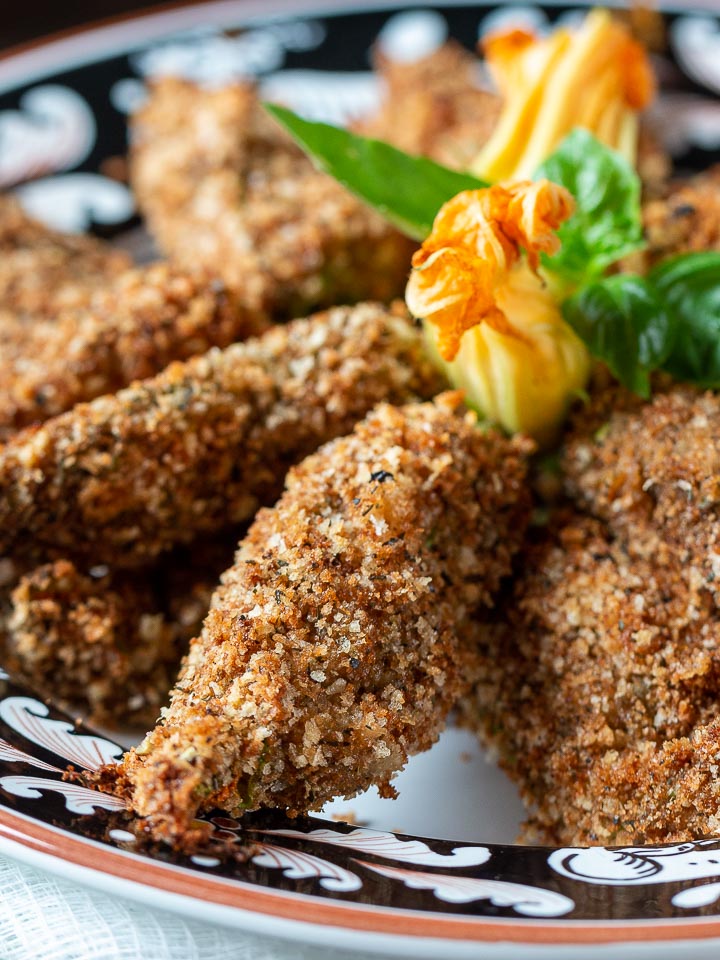 close up of baked stuffed zucchini flowers ready to eat. 