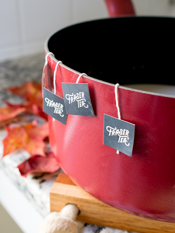 Spicy Chocolate chai tea brewing in a red pot on the stove.