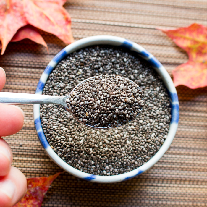 Scoop of black chia seeds.