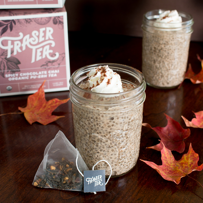 Fraser Tea sachet and box with chai puddings on a wooden table.