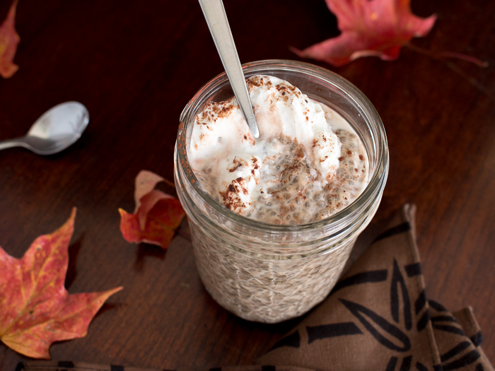 Taking a bite of creamy chia pudding topped with a dollop of coconut whipped cream. 