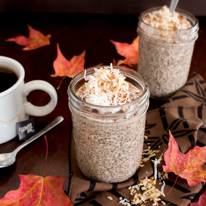 Spicy Chocolate Chai Pu-erh Chia Puddings topped with coconut in a clear jar.