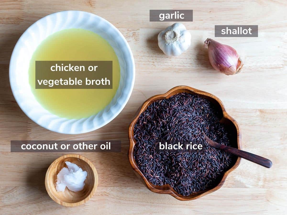 Ingredients to make Instant Pot black rice laid out on a wooden board.