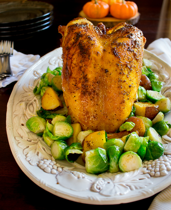 Cooked Roasted Turkey Breast glistening with spices at a Thanksgiving table. 