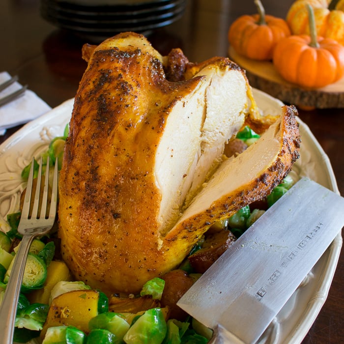 Roasted Turmeric Spiced Turkey Breast served on a plate with Brussel sprouts